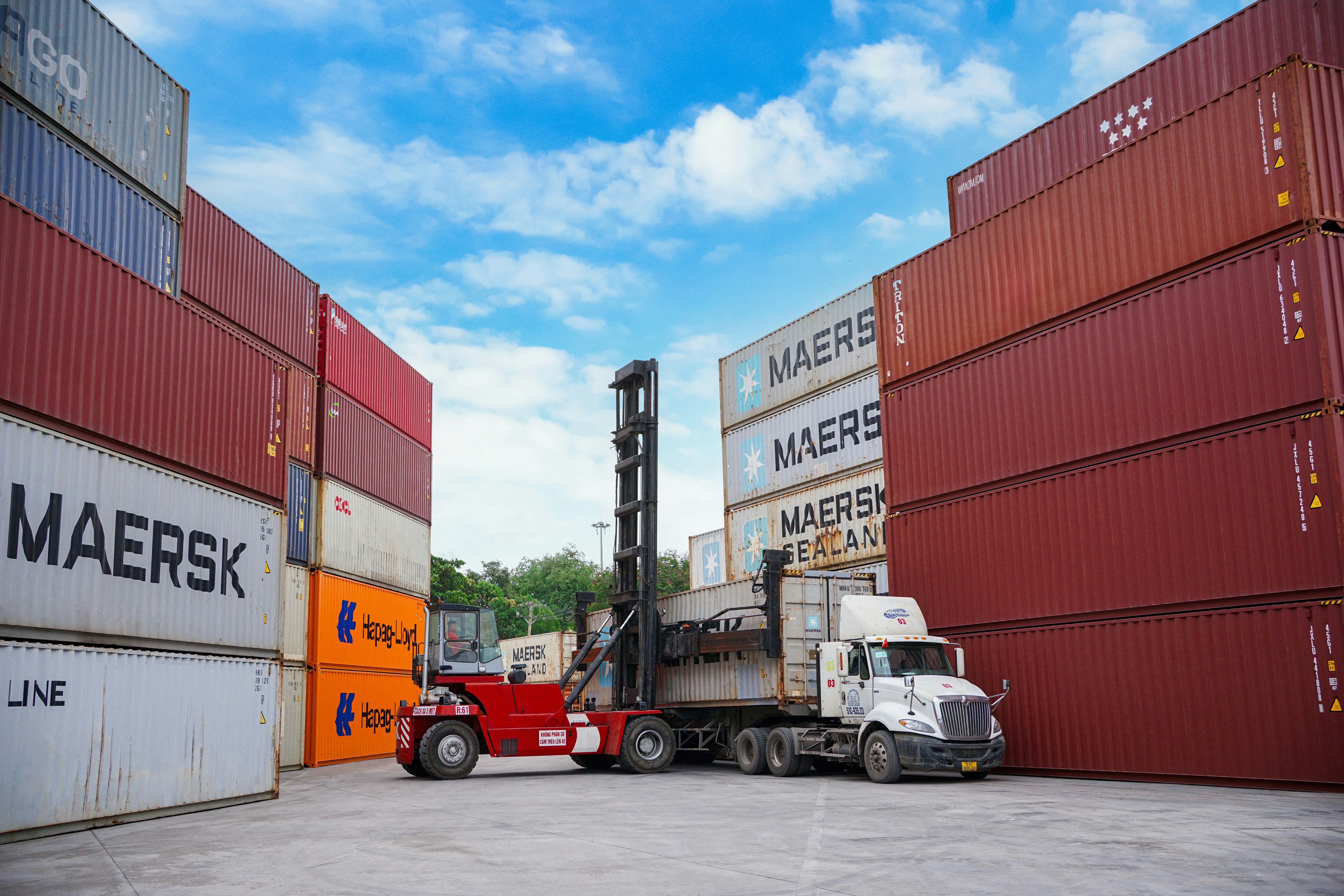 Container vessel docking at a port representing logistics and supply chain operations